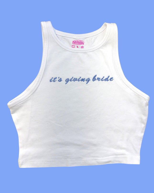 A white crop top with the text "It's giving bride" embroidered on it against a blue background.