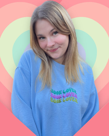 a woman with blonde hair wearing a blue shirt