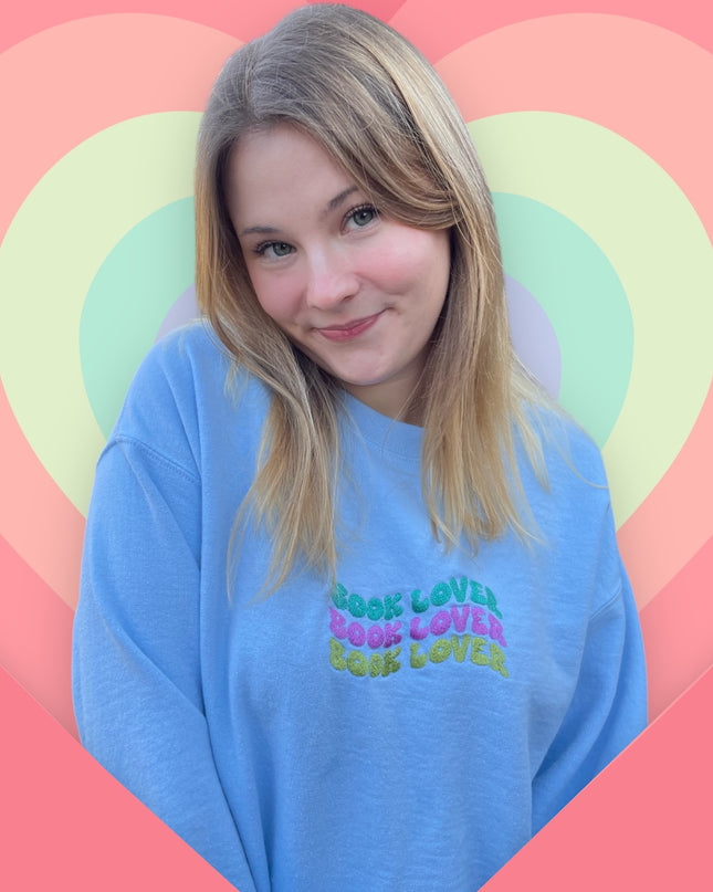 a woman with blonde hair wearing a blue shirt