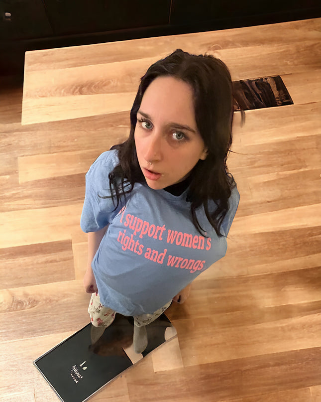 a woman sitting on the floor with a skateboard