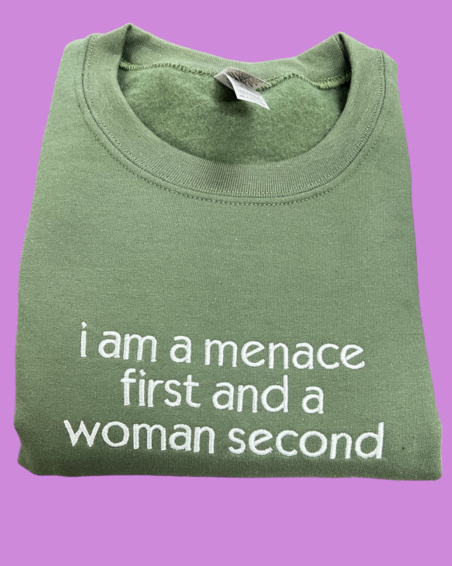 a green t - shirt that says i am a mance first and a woman