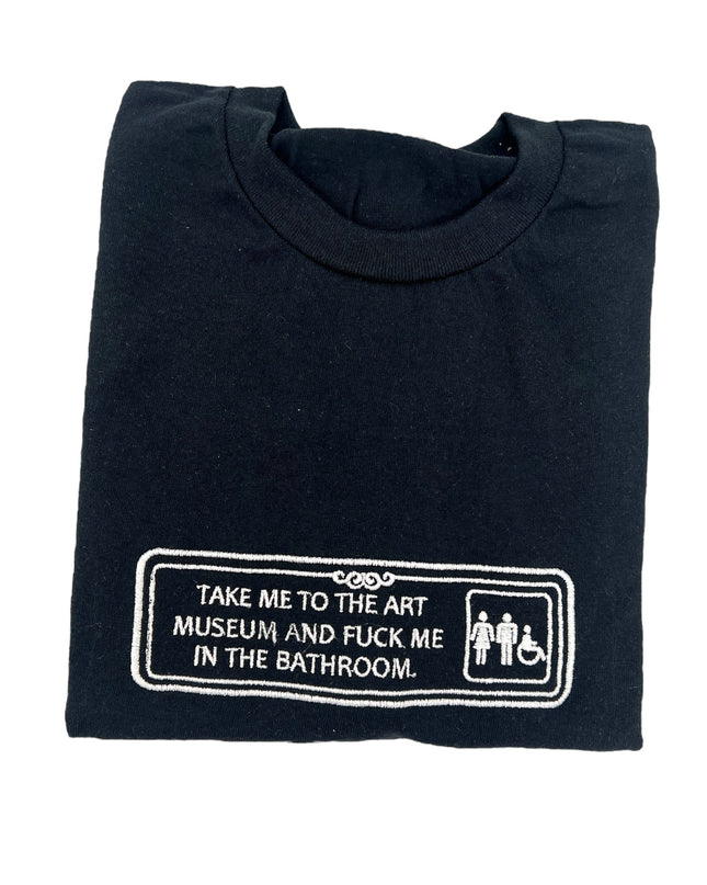 a black t - shirt with a sign that says take me to the museum and