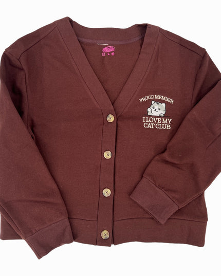 a maroon cardigan sweater with a white dog on it