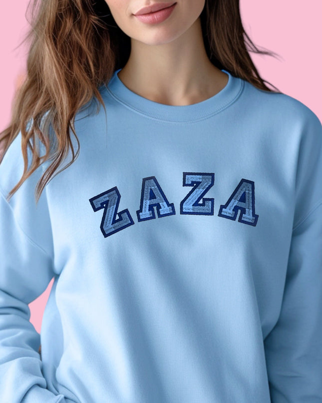 a woman wearing a blue sweatshirt with the letters az on it
