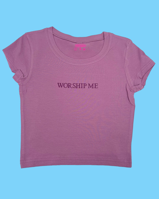 a pink shirt that says worship me on it