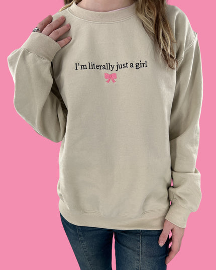 a woman wearing a sweatshirt that says i&#39;m literally just a girl