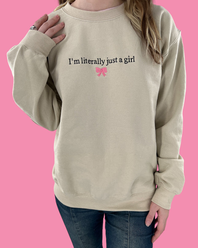 a woman wearing a sweatshirt that says i&#39;m literally just a girl