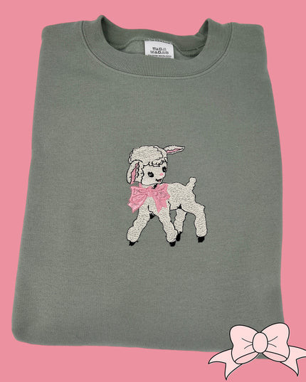 a gray shirt with a pink bow on it