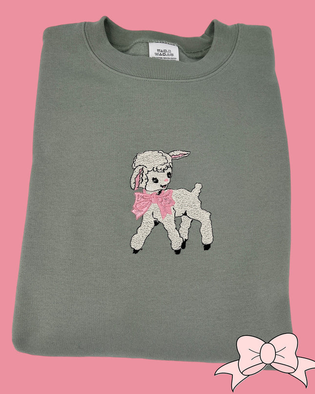 a gray shirt with a pink bow on it