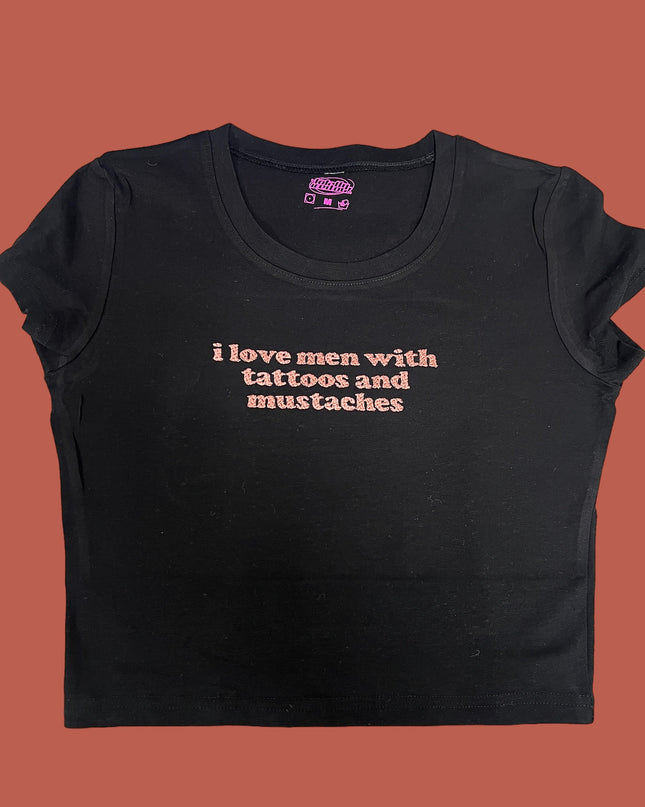 a black t - shirt that says i love men with tattoos and mustaches